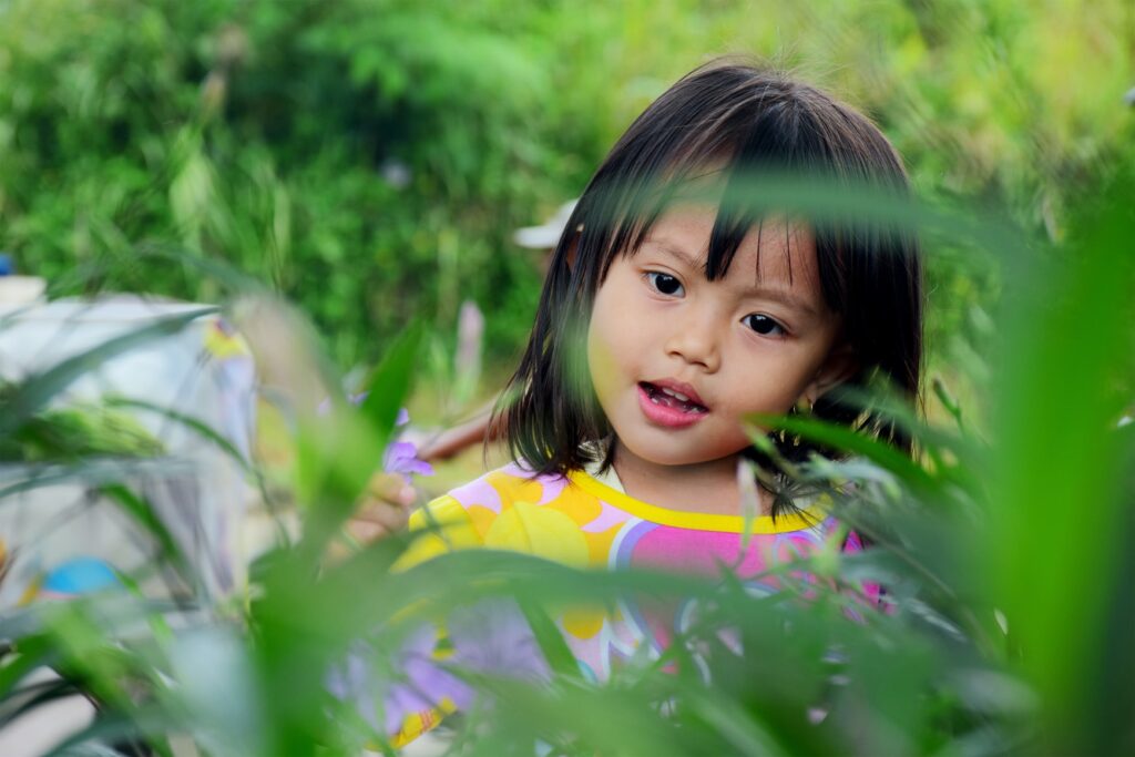 Asian girl playing on meadow